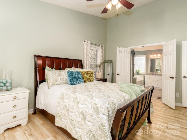 bedroom featuring light wood-style floors, multiple windows, and a ceiling fan