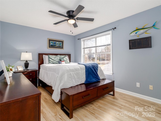 bedroom featuring a ceiling fan, light wood-type flooring, and baseboards