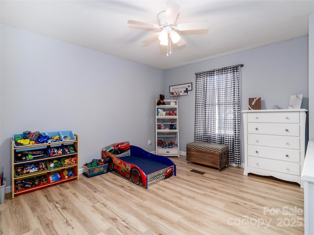 bedroom with ceiling fan and light wood-type flooring