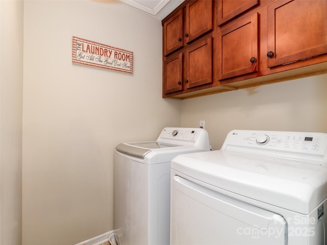 laundry room featuring washer and clothes dryer and cabinet space