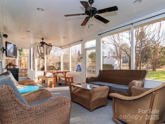 sunroom / solarium with wood ceiling and a ceiling fan