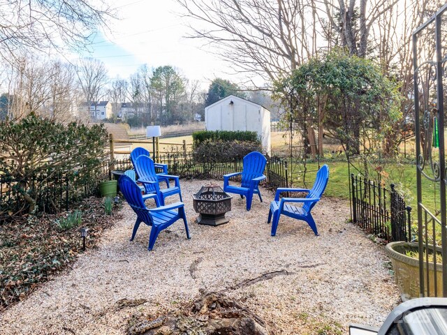 view of yard with fence and a fire pit