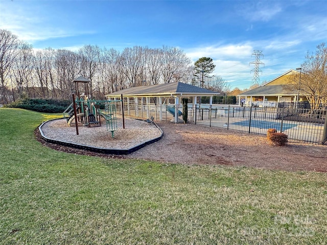 community play area with a yard, a community pool, and fence