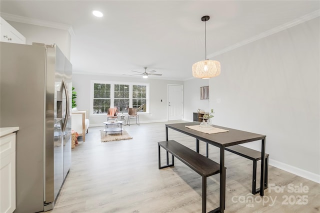 dining area featuring crown molding, ceiling fan, and light wood-type flooring