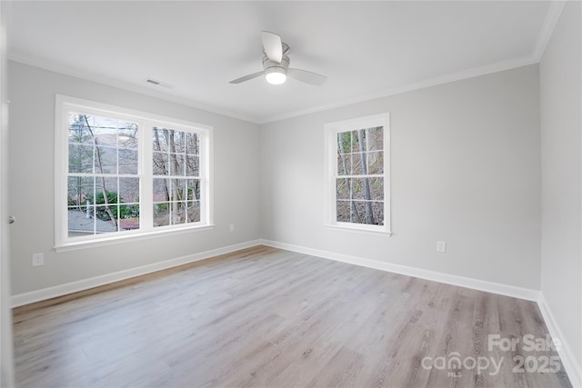 empty room featuring crown molding, ceiling fan, and light wood-type flooring