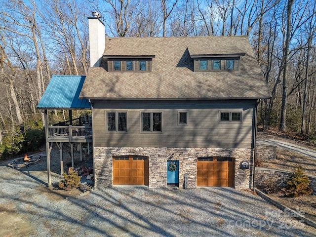 view of front of house with a garage and a deck