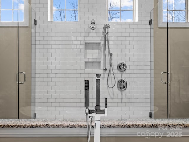 bathroom featuring plenty of natural light and a stall shower