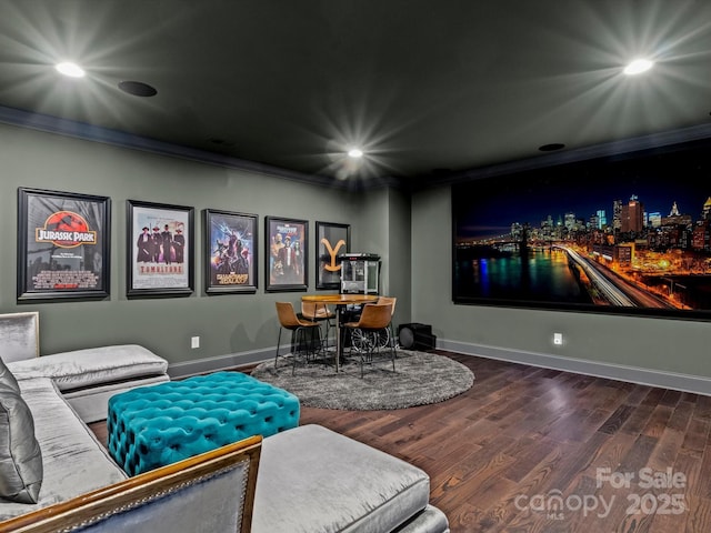 home theater with recessed lighting, baseboards, wood finished floors, and ornamental molding