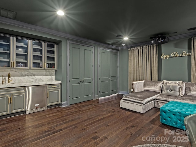 interior space featuring dark wood finished floors, recessed lighting, baseboards, and ornamental molding