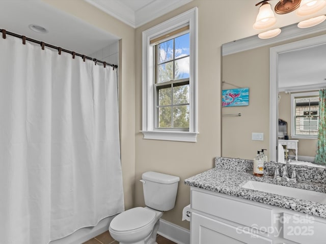 bathroom with crown molding, toilet, vanity, and baseboards