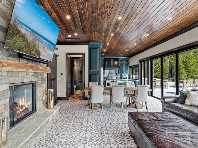 living room featuring recessed lighting, baseboards, wooden ceiling, and a fireplace