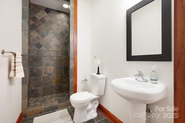 bathroom with toilet and tiled shower