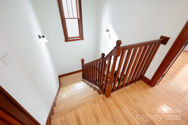 stairs featuring wood-type flooring