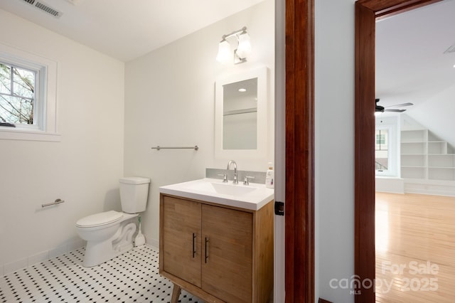 bathroom with vanity, ceiling fan, lofted ceiling, and toilet