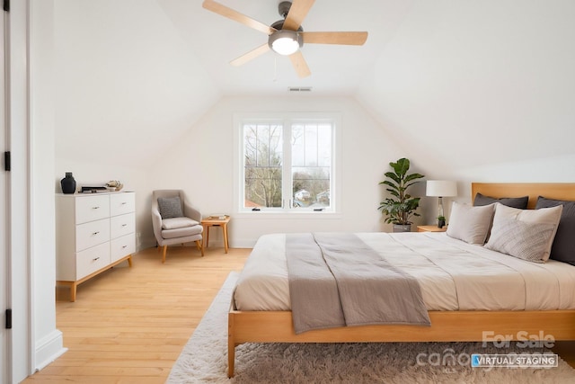 bedroom featuring lofted ceiling, light hardwood / wood-style flooring, and ceiling fan