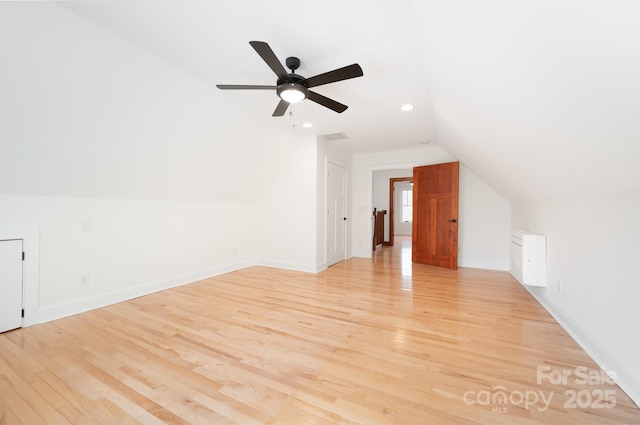 bonus room featuring vaulted ceiling, light hardwood / wood-style floors, and ceiling fan