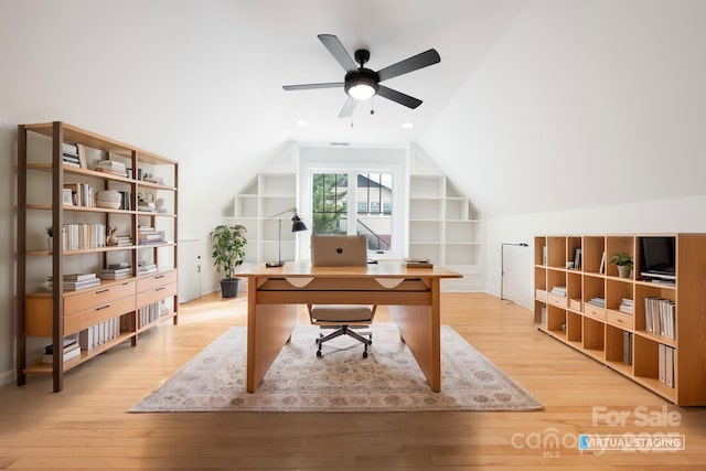 office area featuring lofted ceiling, built in shelves, ceiling fan, and light wood-type flooring