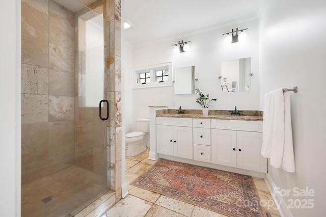 bathroom with vanity, crown molding, a shower with door, and toilet