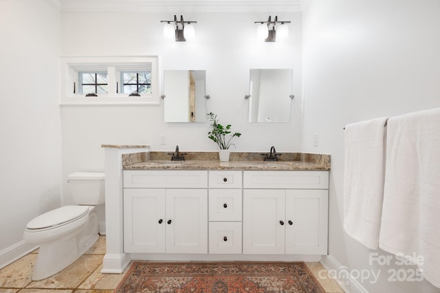 bathroom with crown molding, vanity, and toilet