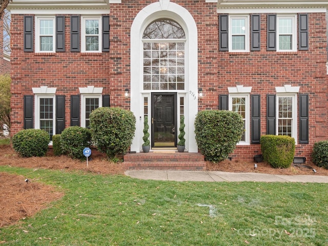 doorway to property with a yard