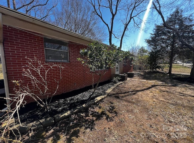 view of side of home with brick siding