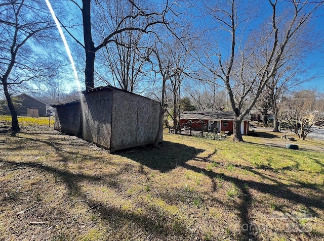 view of yard with a storage shed and an outdoor structure