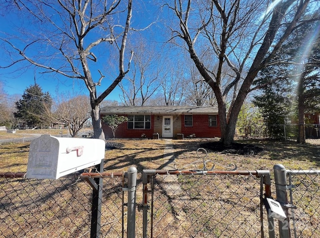 view of front of home featuring brick siding and a fenced front yard