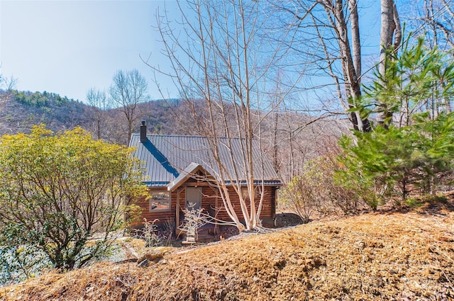 3925 Blackberry Crest Ln, Lenoir, NC 28645 - view of side of home with log exterior, metal roof, a mountain view, and a chimney