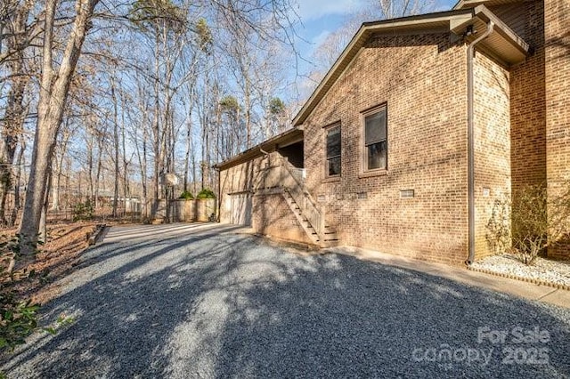 view of property exterior featuring crawl space and brick siding