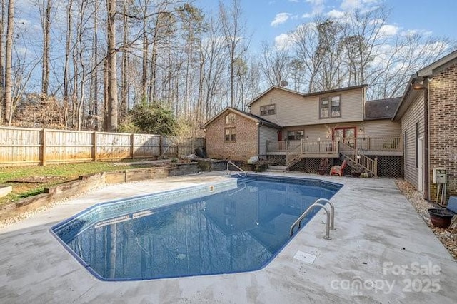 view of swimming pool featuring a fenced backyard, stairway, a fenced in pool, and a wooden deck