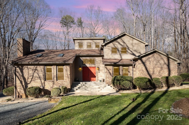 1006 Lost Cv, Weddington, NC 28104 - view of front of property featuring brick siding, a front yard, and a chimney