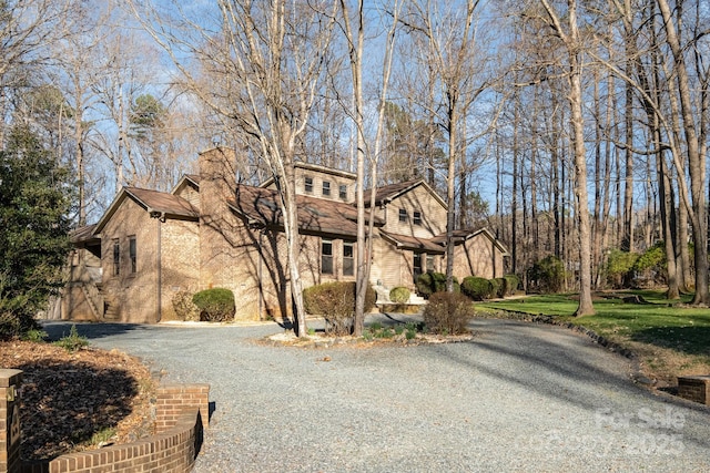 1006 Lost Cv, Weddington, NC 28104 - view of front of home with gravel driveway and a chimney