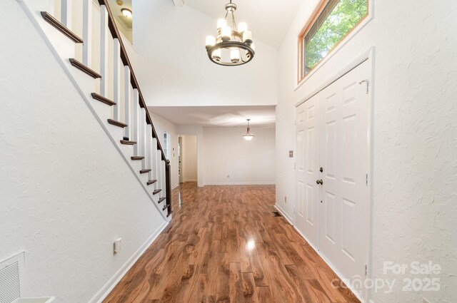 1006 Lost Cv, Weddington, NC 28104 - entrance foyer with a chandelier, stairway, wood finished floors, baseboards, and a textured wall