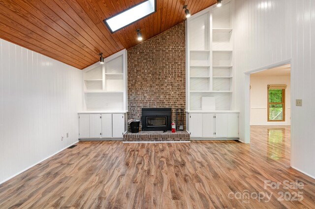 1006 Lost Cv, Weddington, NC 28104 - unfurnished living room with wooden ceiling, built in features, high vaulted ceiling, wood finished floors, and a skylight