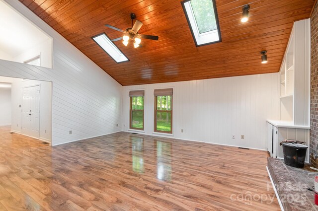 1006 Lost Cv, Weddington, NC 28104 - unfurnished living room featuring a skylight, light wood finished floors, wood ceiling, lofted ceiling, and ceiling fan