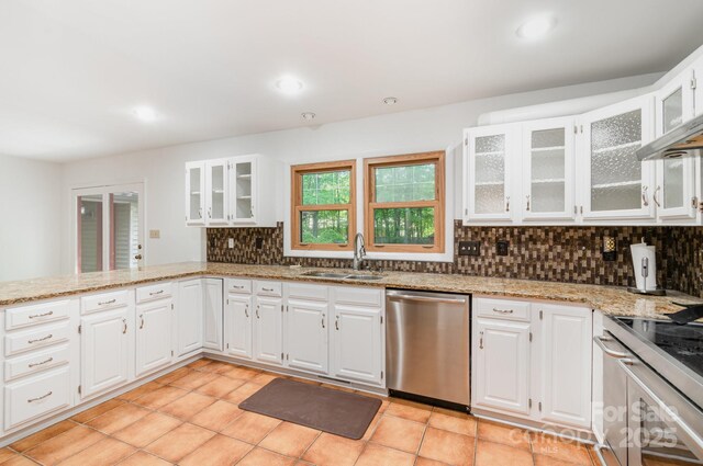 1006 Lost Cv, Weddington, NC 28104 - kitchen with dishwasher, tasteful backsplash, light stone countertops, white cabinetry, and glass insert cabinets