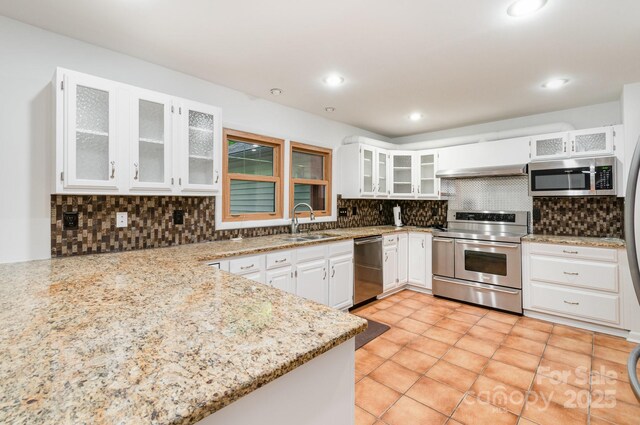 1006 Lost Cv, Weddington, NC 28104 - kitchen featuring stainless steel appliances, tasteful backsplash, white cabinetry, light stone countertops, and recessed lighting