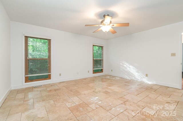 1006 Lost Cv, Weddington, NC 28104 - spare room with stone tile flooring, healthy amount of natural light, ceiling fan, and baseboards