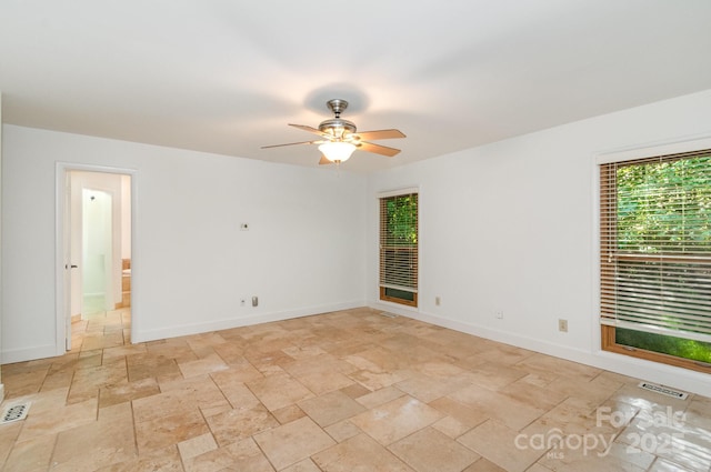 1006 Lost Cv, Weddington, NC 28104 - spare room featuring stone tile floors, ceiling fan, and baseboards