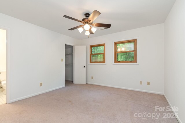 1006 Lost Cv, Weddington, NC 28104 - unfurnished bedroom with light colored carpet, ensuite bath, a walk in closet, and a closet