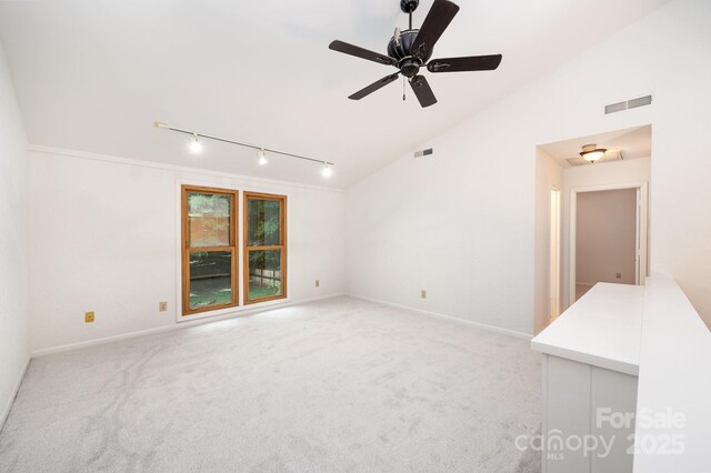 1006 Lost Cv, Weddington, NC 28104 - spare room with track lighting, vaulted ceiling, light colored carpet, and a ceiling fan