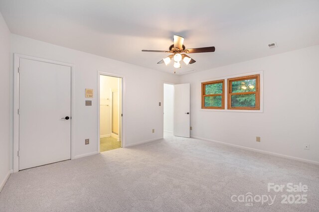 1006 Lost Cv, Weddington, NC 28104 - unfurnished bedroom with light carpet, ensuite bath, and a ceiling fan