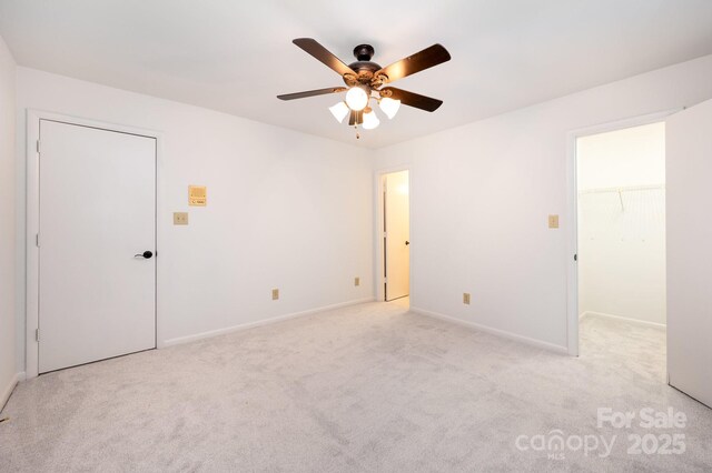 1006 Lost Cv, Weddington, NC 28104 - unfurnished bedroom featuring light colored carpet, a spacious closet, and ceiling fan