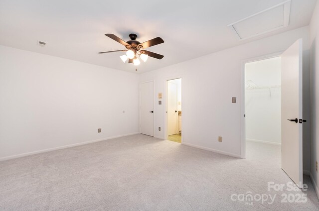 1006 Lost Cv, Weddington, NC 28104 - unfurnished bedroom featuring light colored carpet, a walk in closet, baseboards, ceiling fan, and connected bathroom
