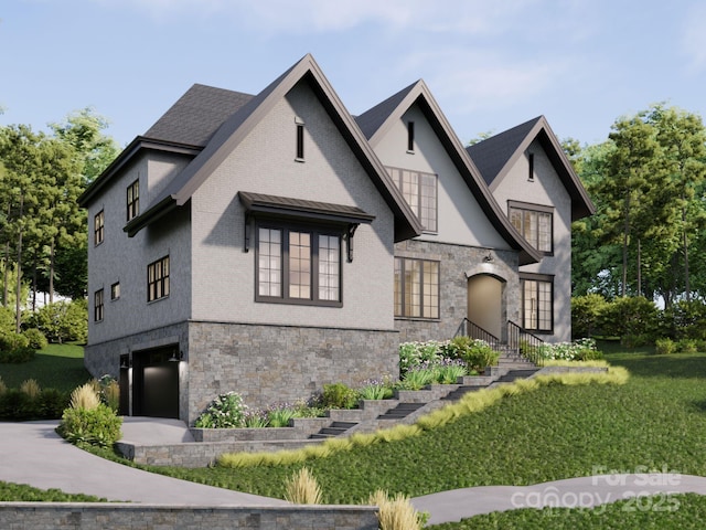 tudor home featuring a garage and a front yard