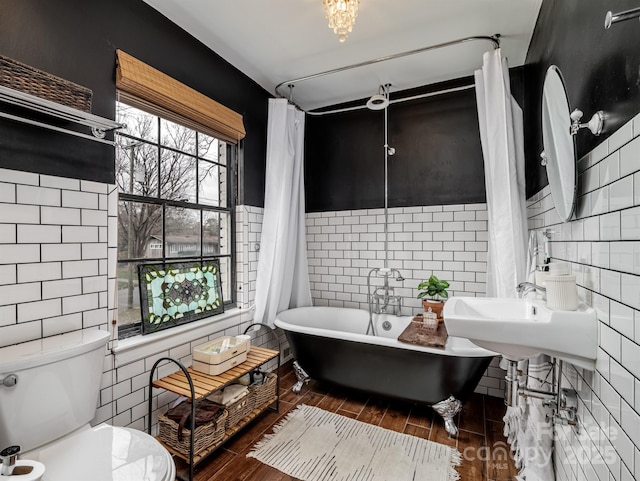 bathroom with tile walls, sink, and toilet