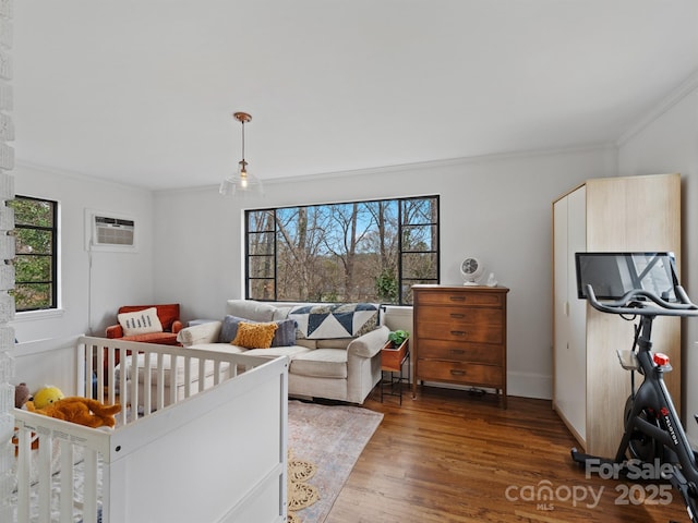 bedroom featuring multiple windows, a wall unit AC, ornamental molding, and dark hardwood / wood-style floors