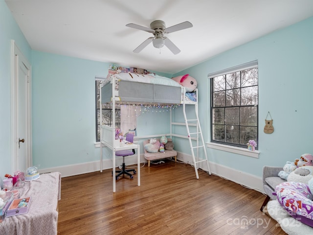 bedroom with ceiling fan and dark hardwood / wood-style flooring