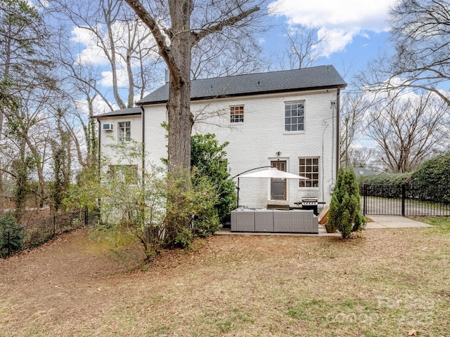 back of house featuring an outdoor living space and a patio area