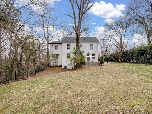 back of house featuring a yard and central AC unit